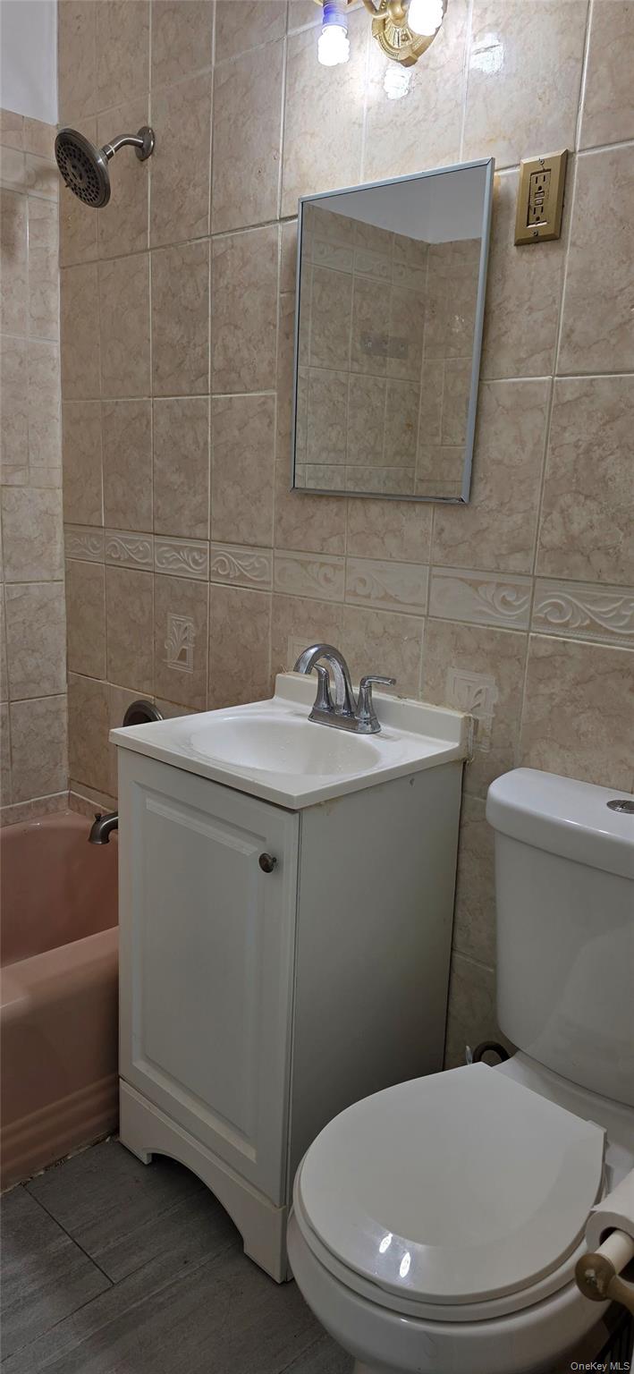 1574 Paulding Avenue, Unit 2 Bronx, NY 10462 - Photo 5 of 25 a white toilet sitting next to a bath tub