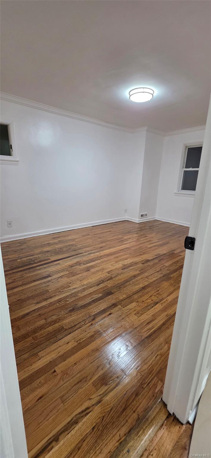1574 Paulding Avenue, Unit 2 Bronx, NY 10462 - Photo 7 of 25 a view of empty room with wooden floor