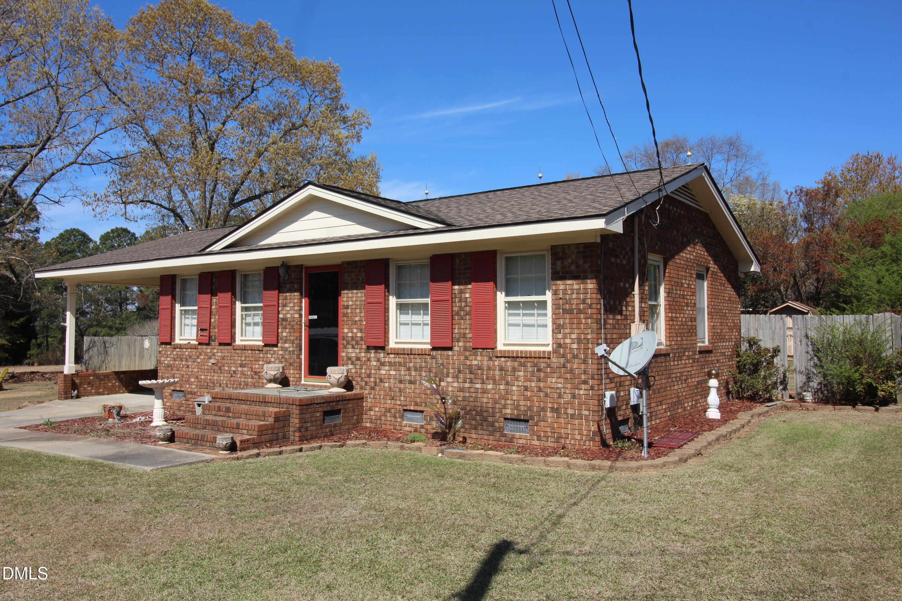 56 Ash Street Coats, NC 27521 - Photo 2 of 28 a front view of a house with garden