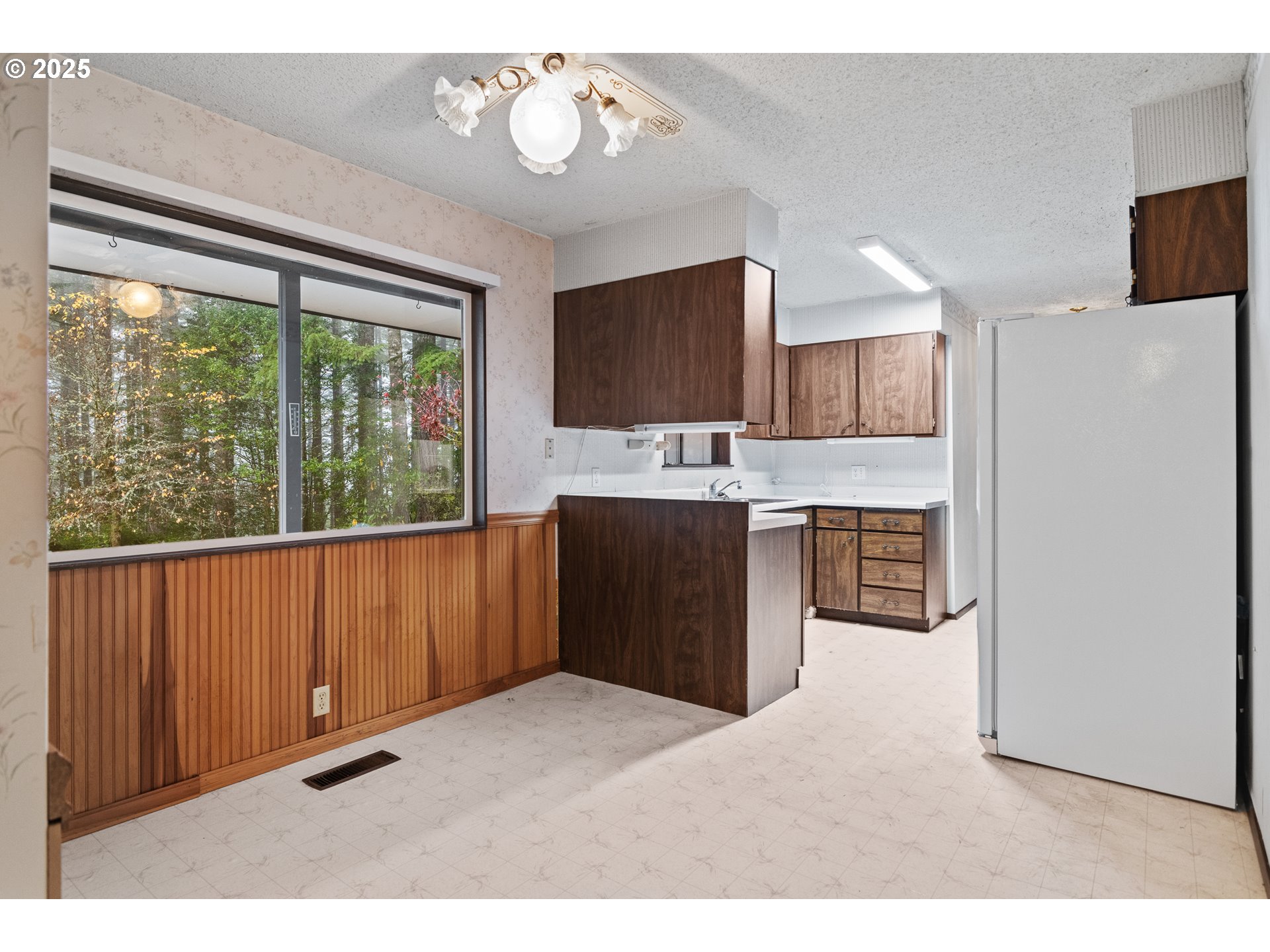 57247 Fairview Road Coquille, OR 97423 - Photo 18 of 45 a kitchen with kitchen island a stove a refrigerator a sink dishwasher with a dining table and chairs