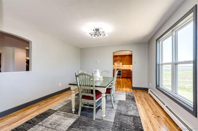 a bathroom with a granite countertop sink a toilet and mirror