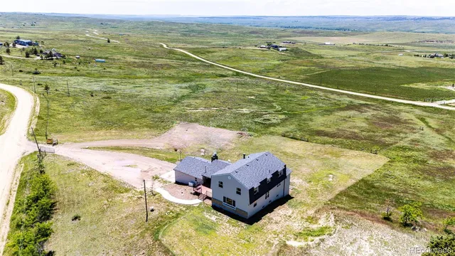 a view of a balcony with wooden floor chairs and ocean view