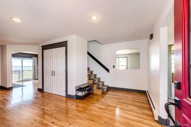 a view of a room with furniture wooden floor and windows