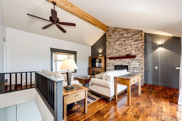a living room with furniture a piano and a flat screen tv