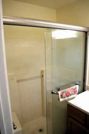 a bathroom with a shower and a sink