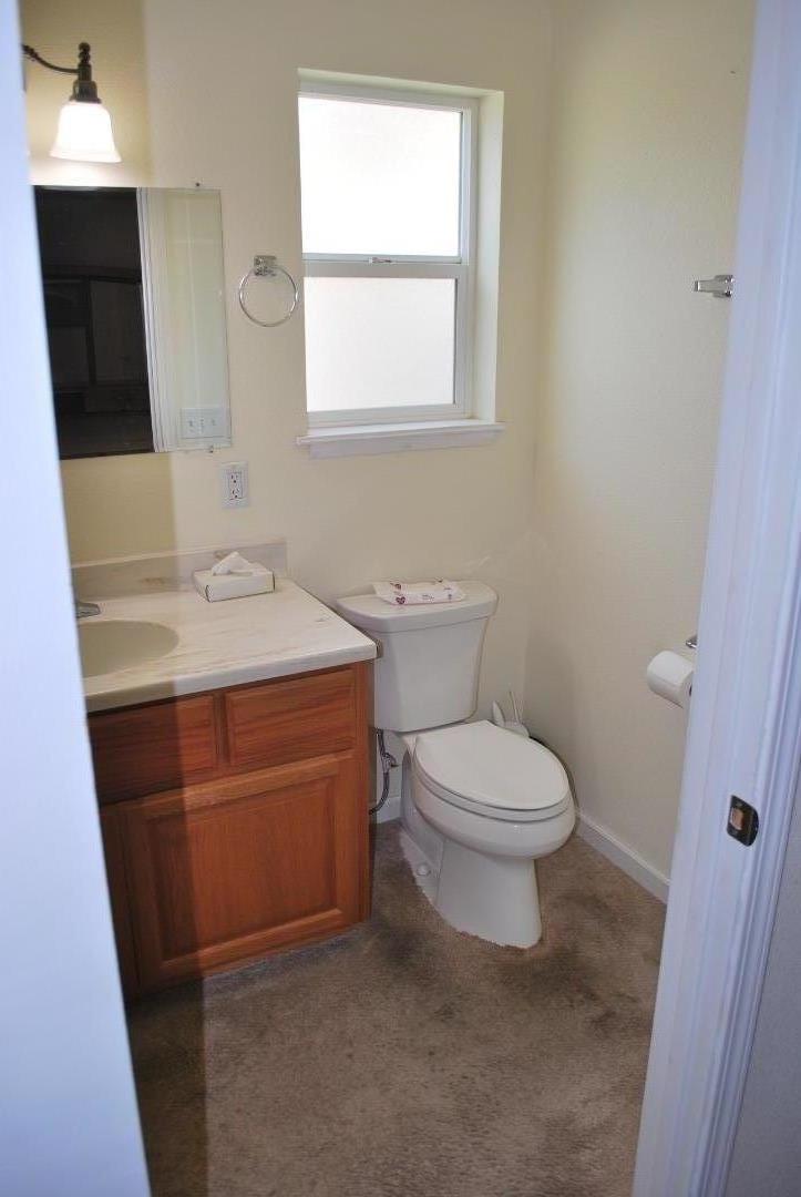 9194 Coker Road Salinas, CA 93907 - Photo 12 of 27 a bathroom with a toilet sink and mirror