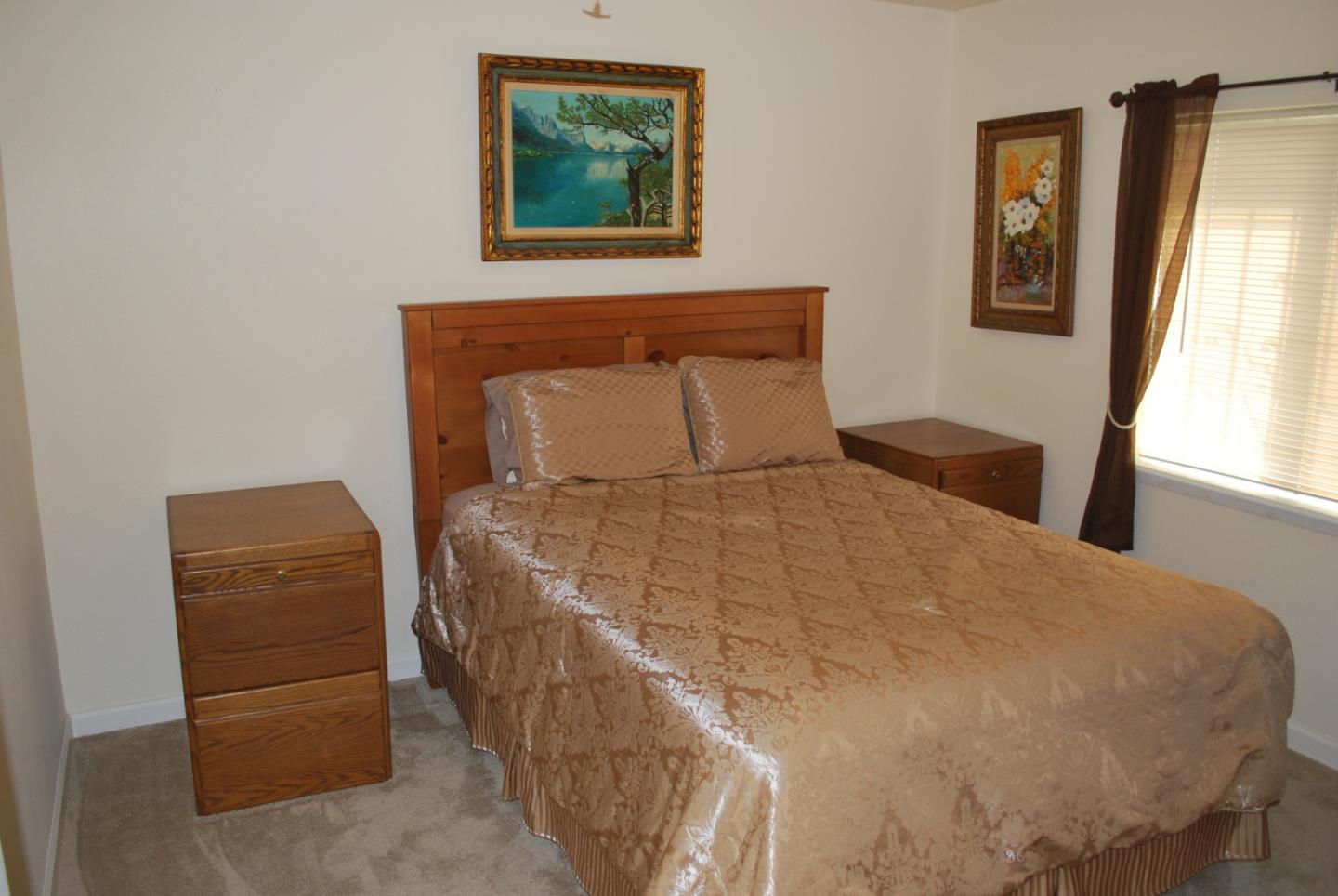 9194 Coker Road Salinas, CA 93907 - Photo 14 of 27 a bed sitting in a bedroom next to a window