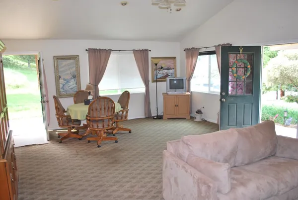 a living room filled with furniture and a window