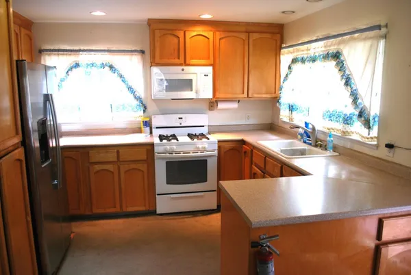 a kitchen with a stove a sink and a refrigerator