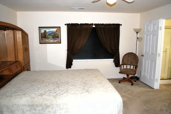 a bedroom with a bed and a dresser