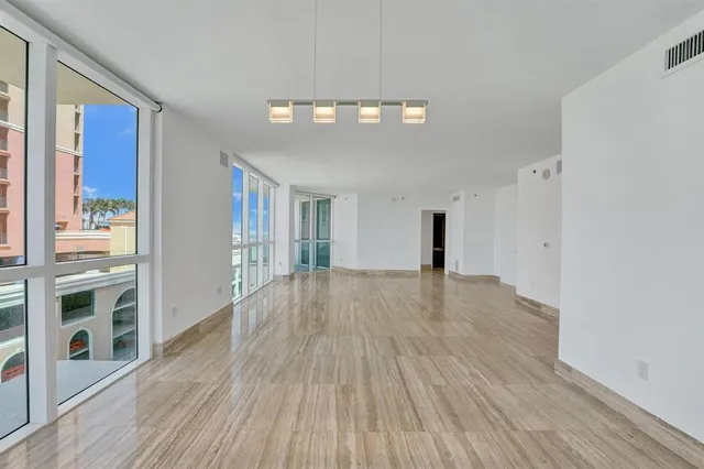 a kitchen with stainless steel appliances granite countertop a refrigerator a stove and a wooden floors