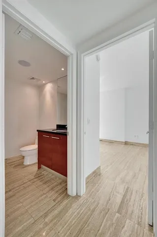 a view of empty room with wooden floor and window