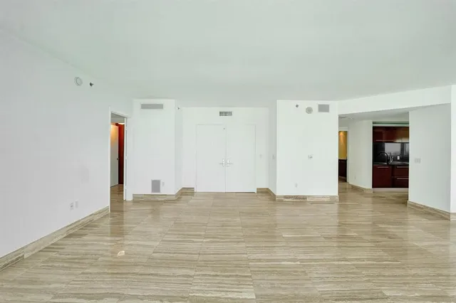 a view of a kitchen with a sink and refrigerator