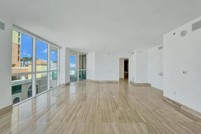 a kitchen with granite countertop a refrigerator and a stove top oven