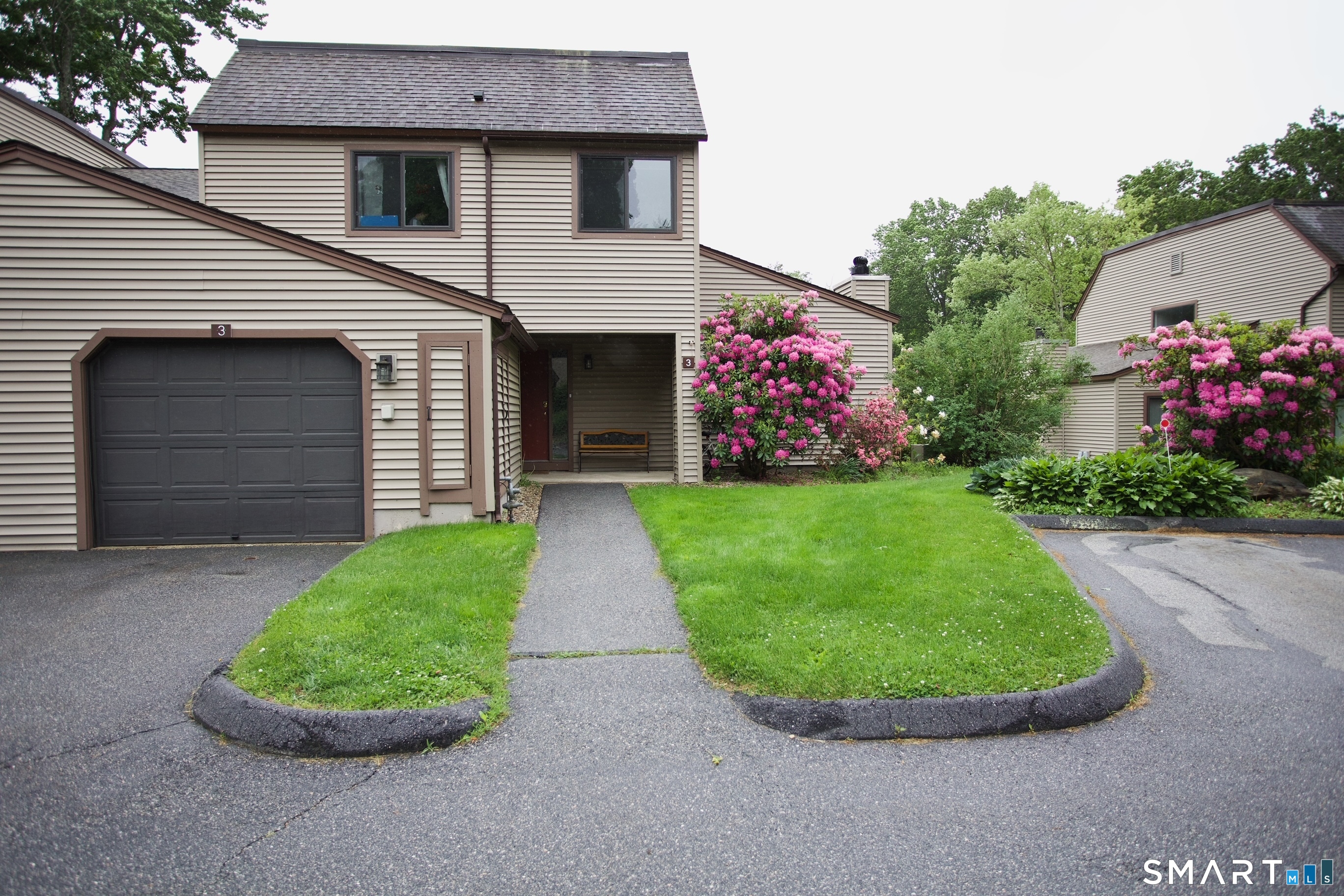 3 Walnut Lane, Unit 3 Avon, CT 06001 - Photo 1 of 22 a view of a white house with a small yard and a garden