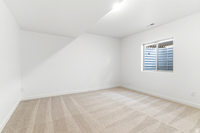 7243 West Terraine Road West Jordan, UT 84081 - Photo 26 of 31 Bright interior space featuring light-toned carpeting and a window with a window well
