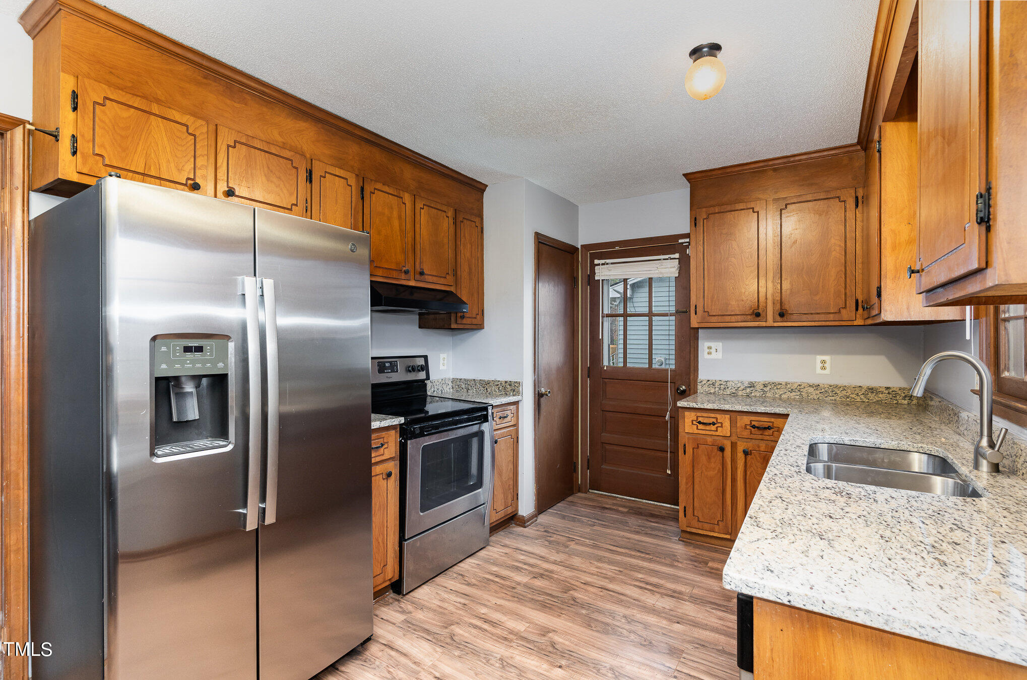 4100 Kilcullen Drive Raleigh, NC 27604 - Photo 8 of 19 a kitchen with stainless steel appliances granite countertop a sink stove and refrigerator