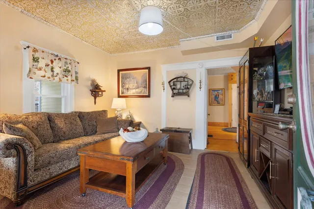 a kitchen with stainless steel appliances kitchen island granite countertop a table chairs and a refrigerator