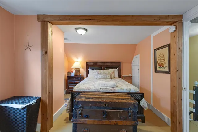 a bedroom with bed and a large mirror
