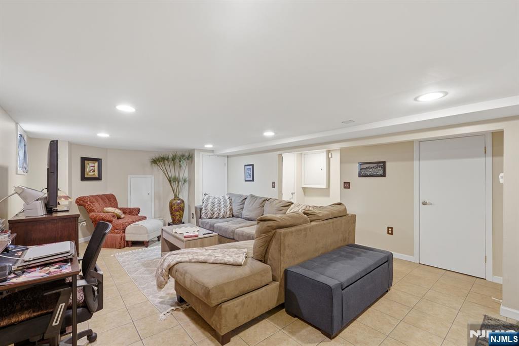 385 Berkeley Avenue Bloomfield, NJ 07003 - Photo 27 of 39 a living room with furniture and a wooden floor