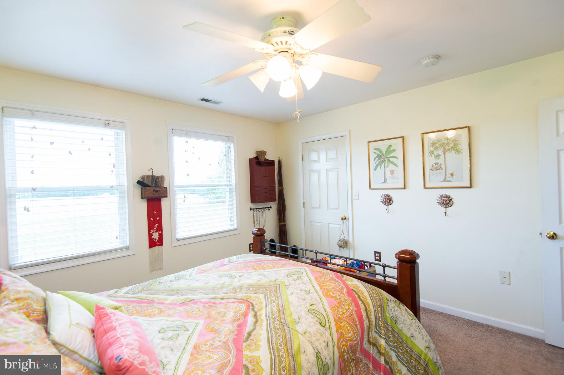 12136 Holly Road Ridgely, MD 21660 - Photo 41 of 136 a bedroom with a bed and a chandelier