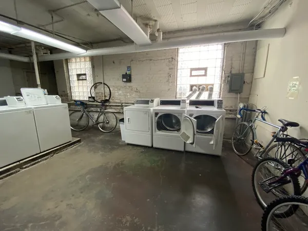 a utility room with multiple dryer and washer