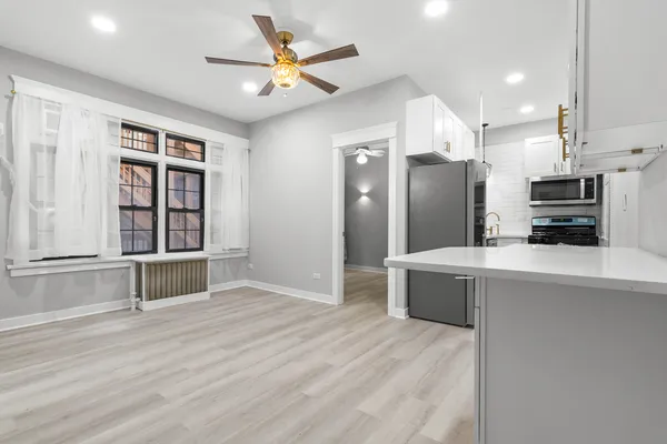 a large kitchen with a large counter top appliances and cabinets