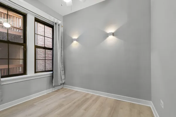 an empty room with windows and entrance