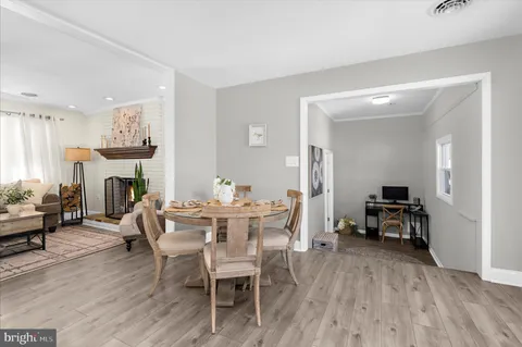a kitchen with granite countertop a sink stainless steel appliances and white cabinets