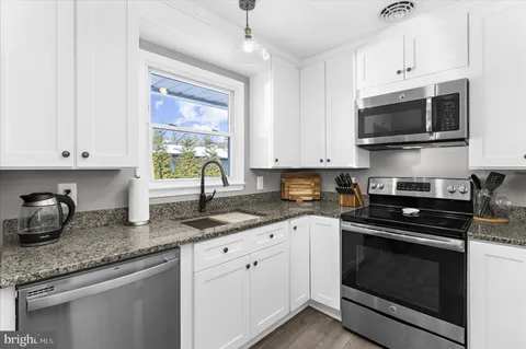 a view of a workspace with furniture and wooden floor