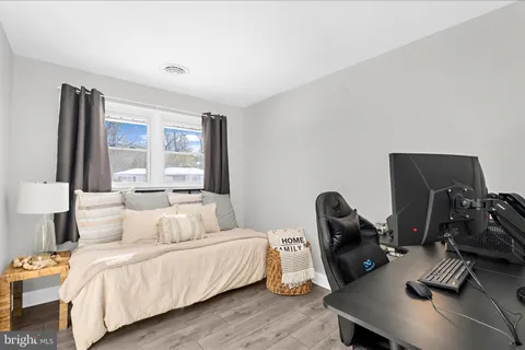 a view of a workspace with furniture and wooden floor