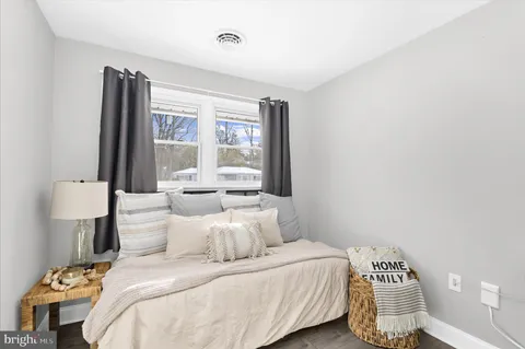 a bedroom with a large bed and a potted plant