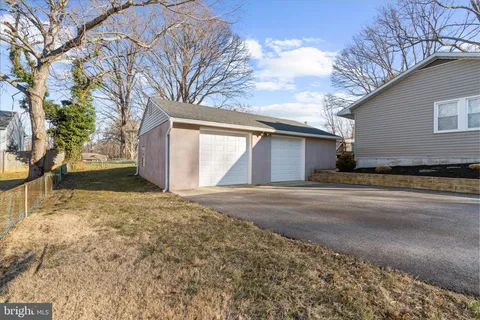 a view of a house with a yard and garage