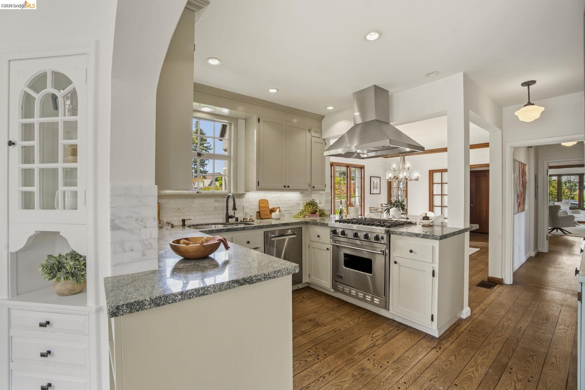 1087 Hubert Road Oakland, CA 94610 - Photo 15 of 67 Gourmet kitchen featuring a stainless steel range with matching ventilation hood, granite countertops, marble tile backsplash, and recessed lighting