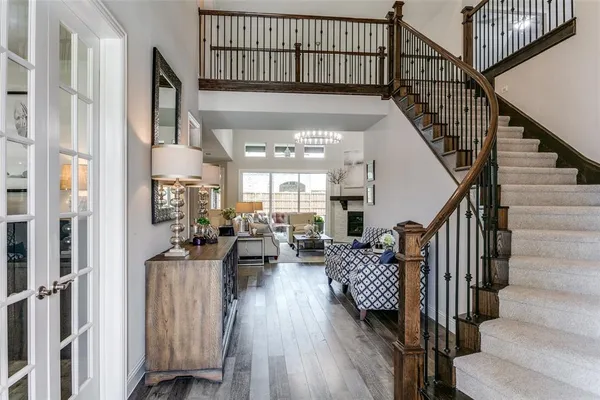 a view of entryway and hall with wooden floor