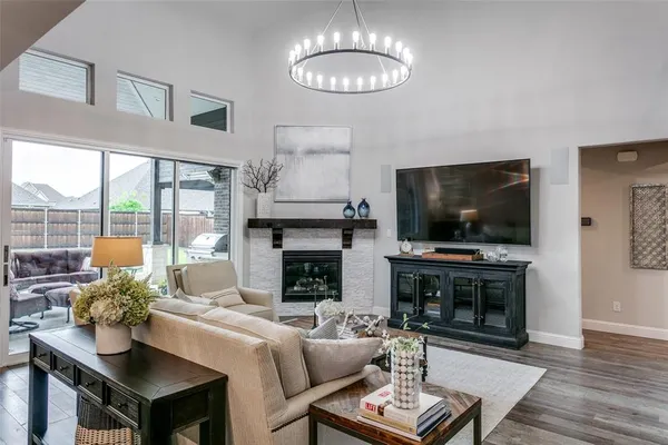 a living room with furniture a flat screen tv and a fireplace