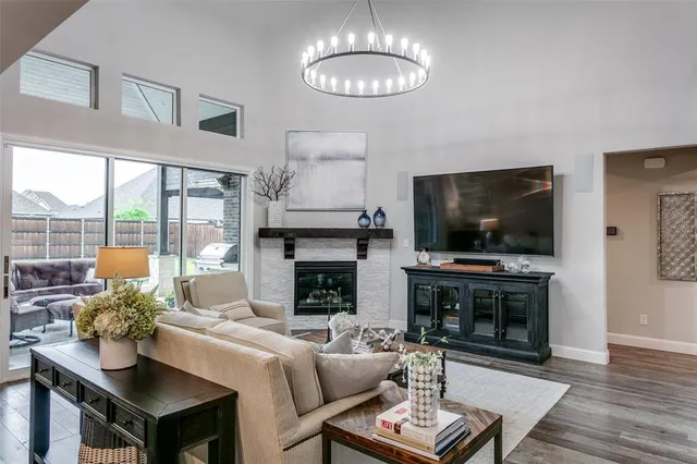 a living room with furniture a flat screen tv and a fireplace
