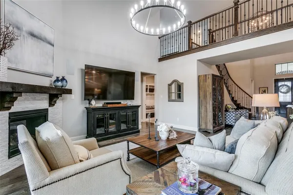 a living room with furniture a flat screen tv and a fireplace