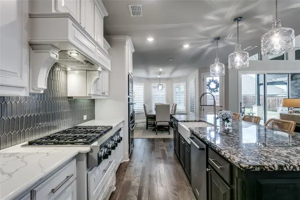 a kitchen with lots of counter top space and stainless steel appliances