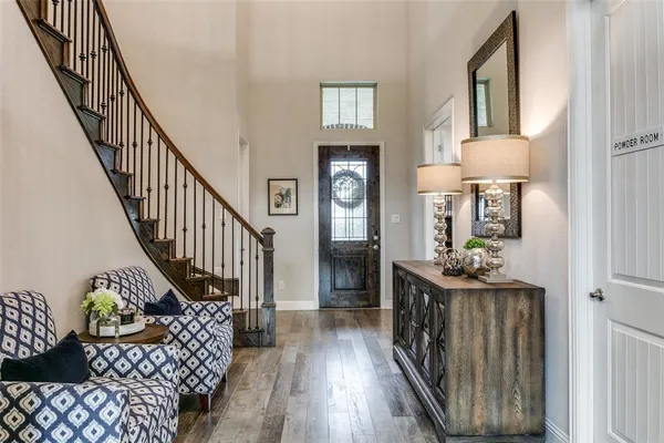 a view of entryway with wooden floor and chandelier