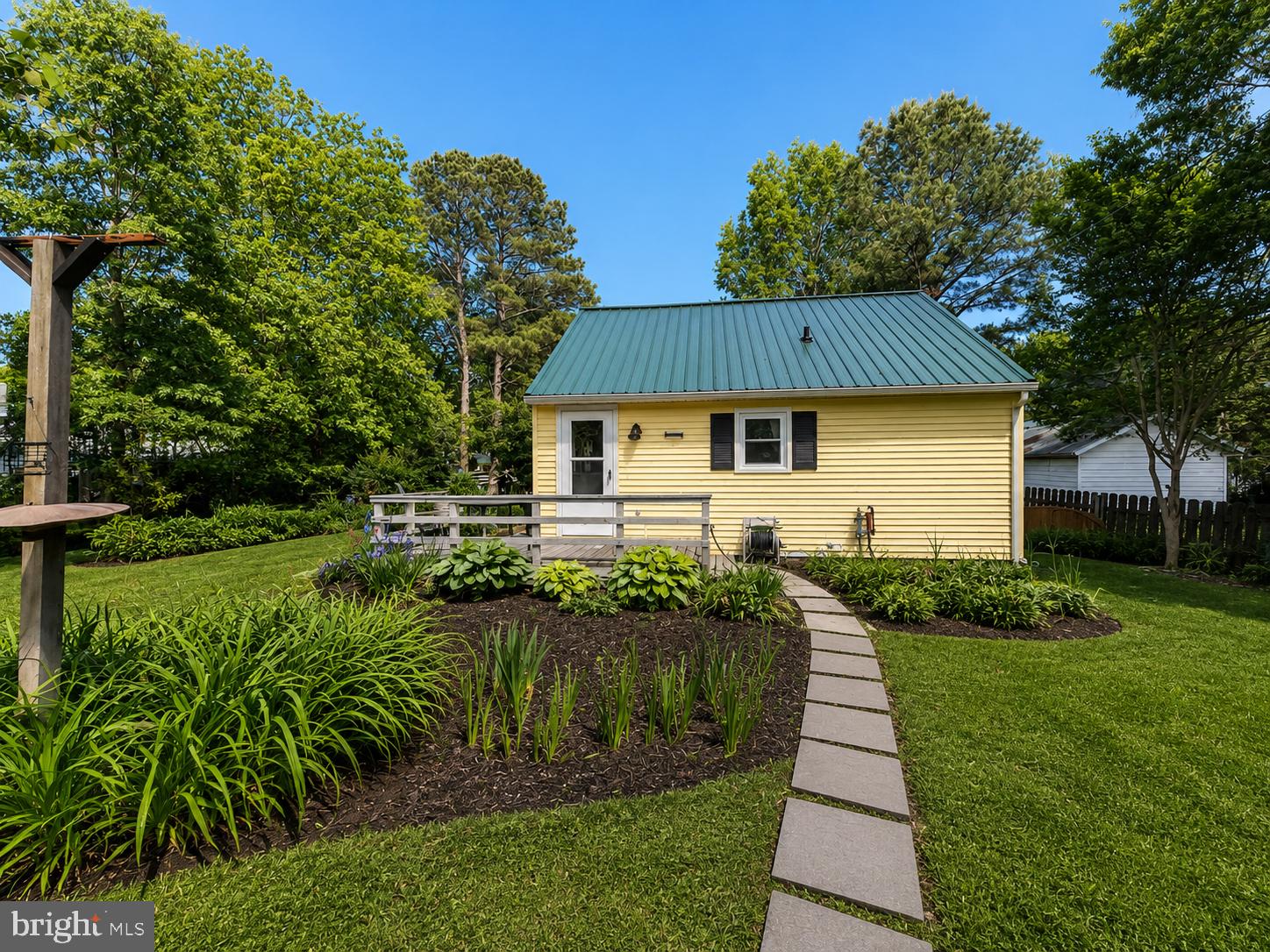 22597 Pot Pie Road Wittman, MD 21676 - Photo 3 of 10 a front view of a house with a yard table and chairs