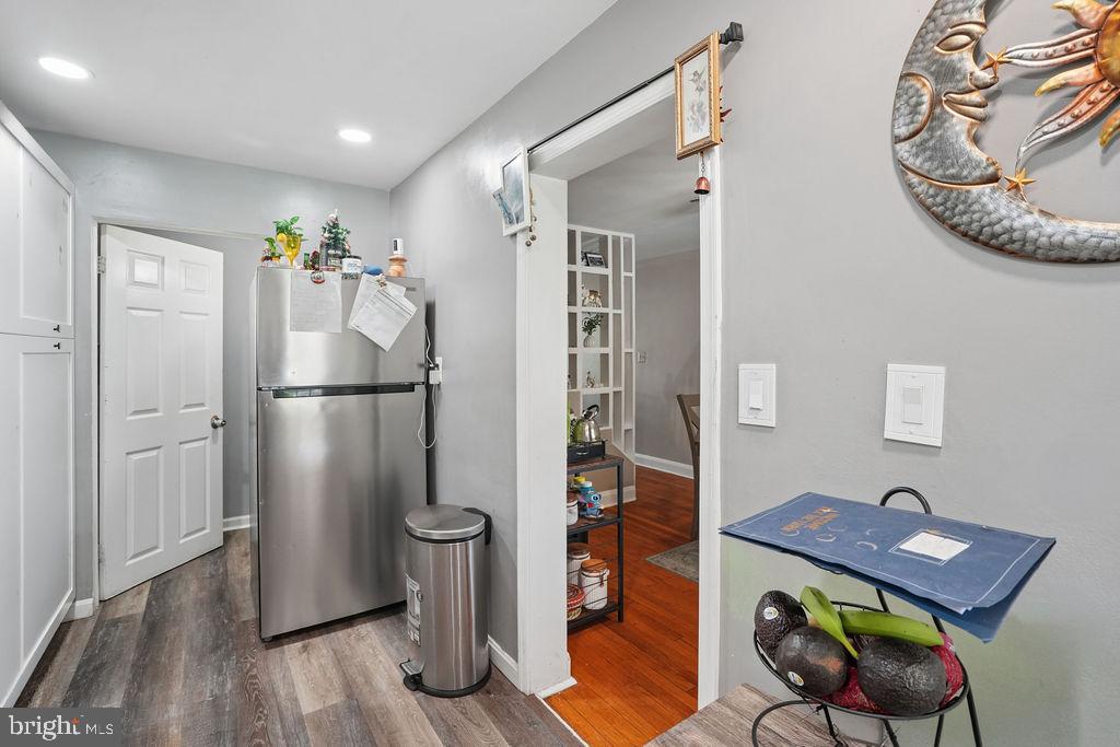 1918 Church Road Baltimore, MD 21222 - Photo 9 of 29 a view of a hallway to a livingroom and a dining room with wooden floor
