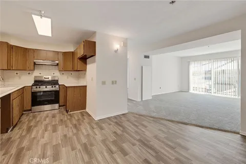 a kitchen with stainless steel appliances granite countertop a refrigerator sink and stove
