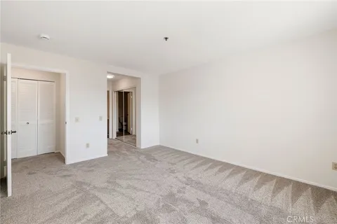 a spacious bathroom with a glass shower door and a sink