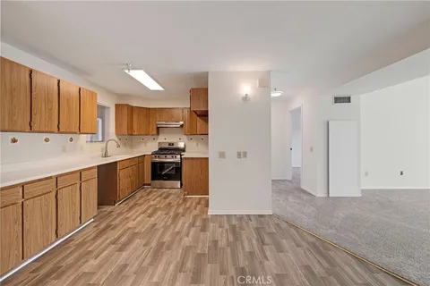 a kitchen with a sink a refrigerator and cabinets