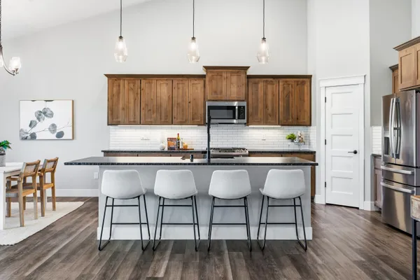 a kitchen with stainless steel appliances granite countertop a stove a sink and a microwave