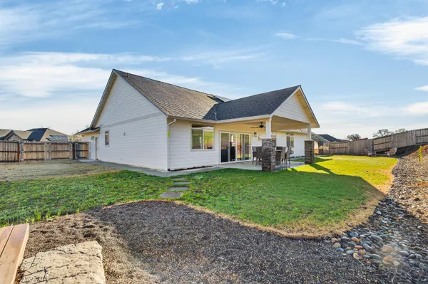 a view of a house with swimming pool and sitting area