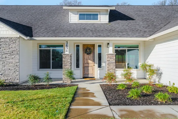 a front view of a house with garden