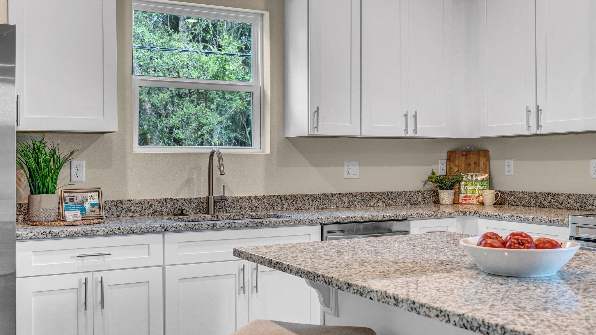 933 Tupelo Road Southwest Palm Bay, FL 32908 - Photo 11 of 31 a kitchen with a sink and cabinets
