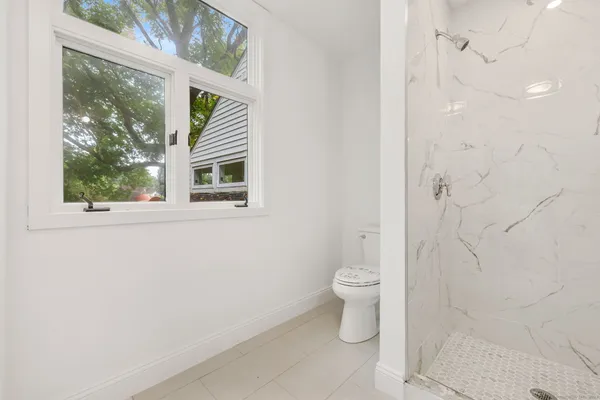 a bathroom with a toilet a sink and a shower